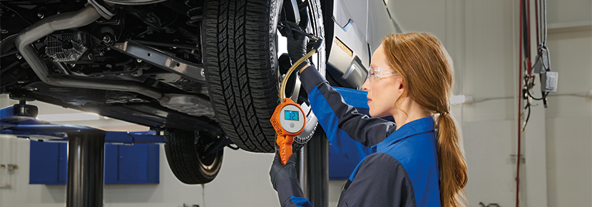 A Subaru technician checking tire pressure. | Bob Johnson Subaru Watertown in Watertown NY