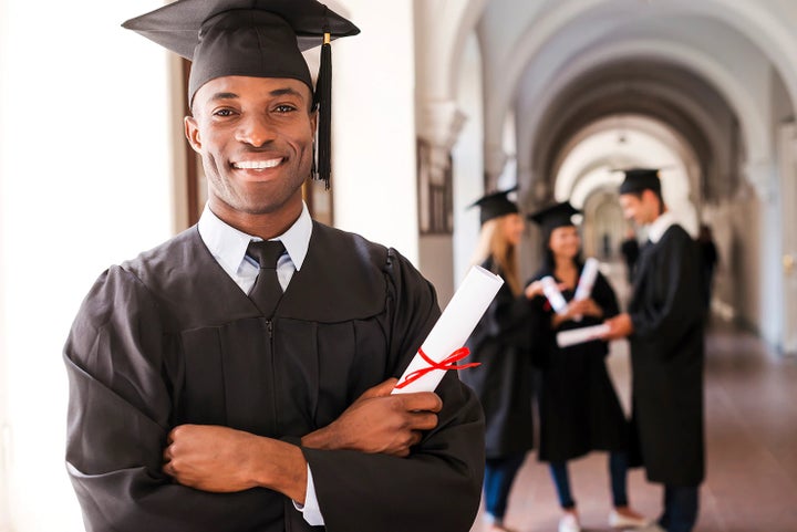 college graduate holding his diploma | Bob Johnson Subaru Watertown in Watertown NY
